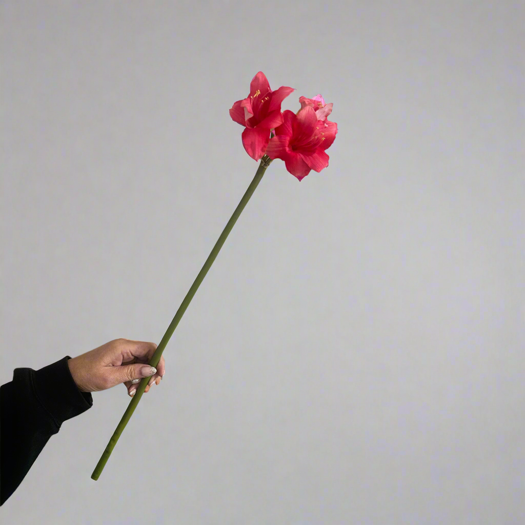 Single artificial pink amaryllis stem with large trumpet-shaped bloom and long green stem