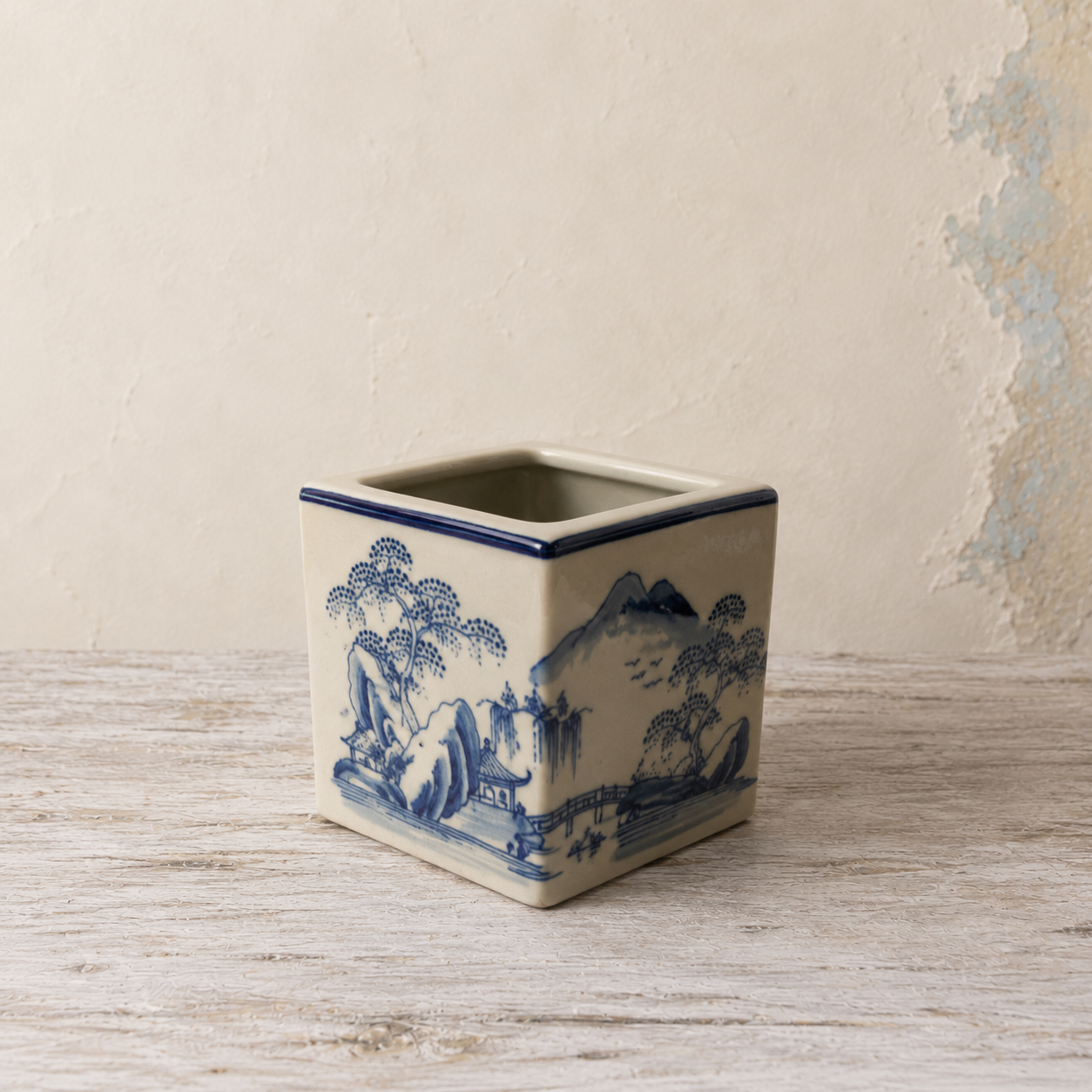 Blue and white Oriental ceramic cube planter with a traditional landscape design.