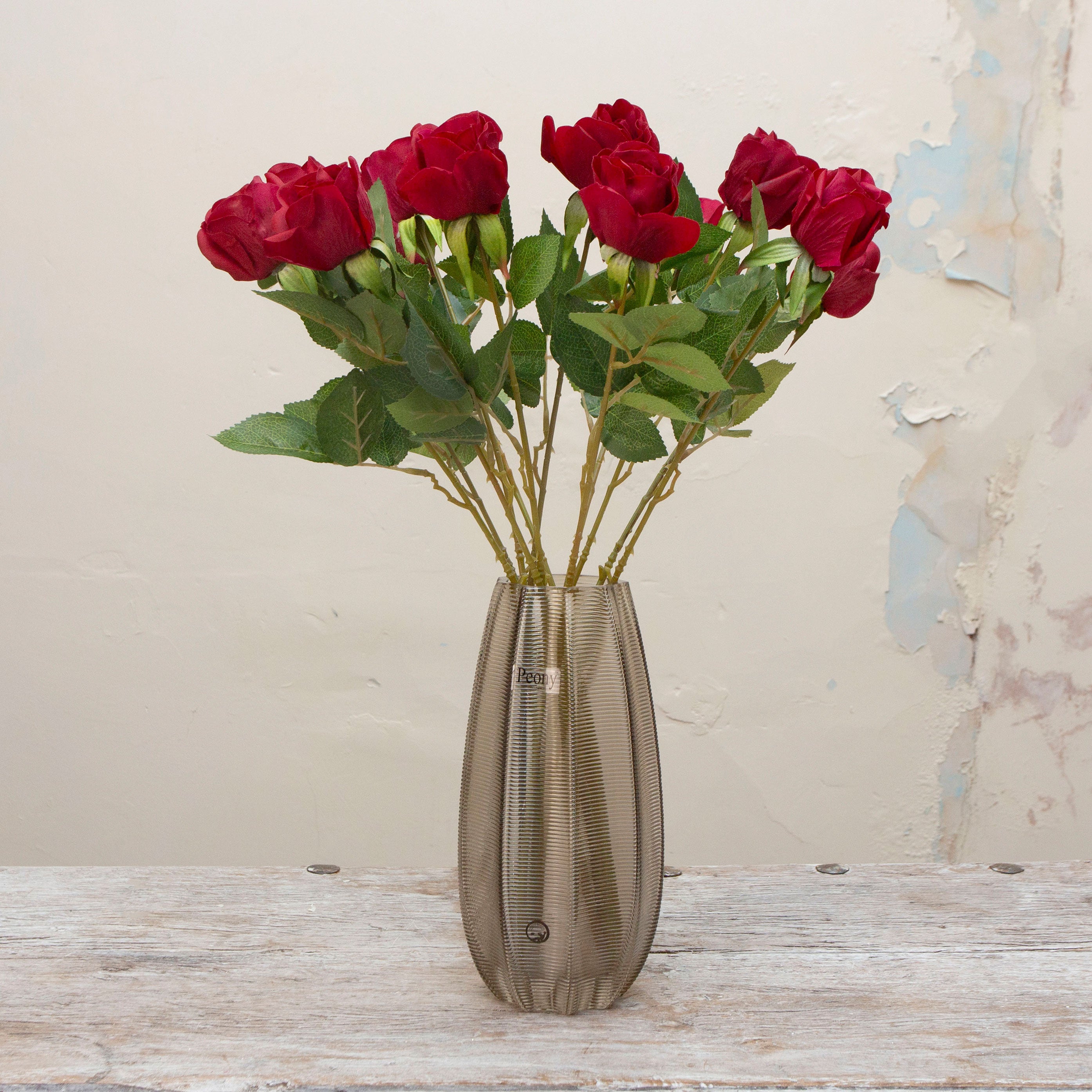 Artificial red Real Touch Rose with Foliage on a Long Stem displayed in a glass vase