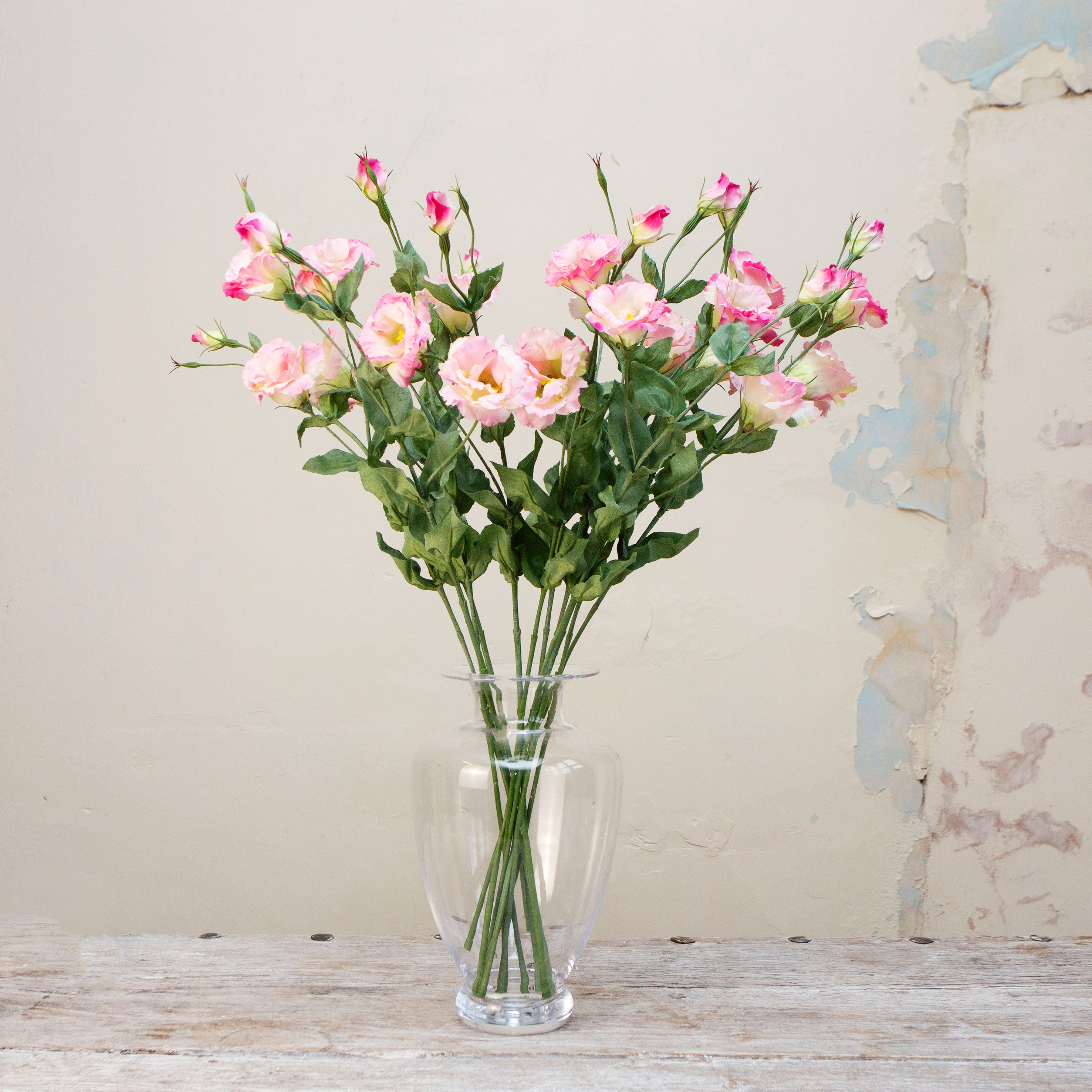 Artificial pale pink lisianthus spray stems displayed together in a vase for styling purposes.