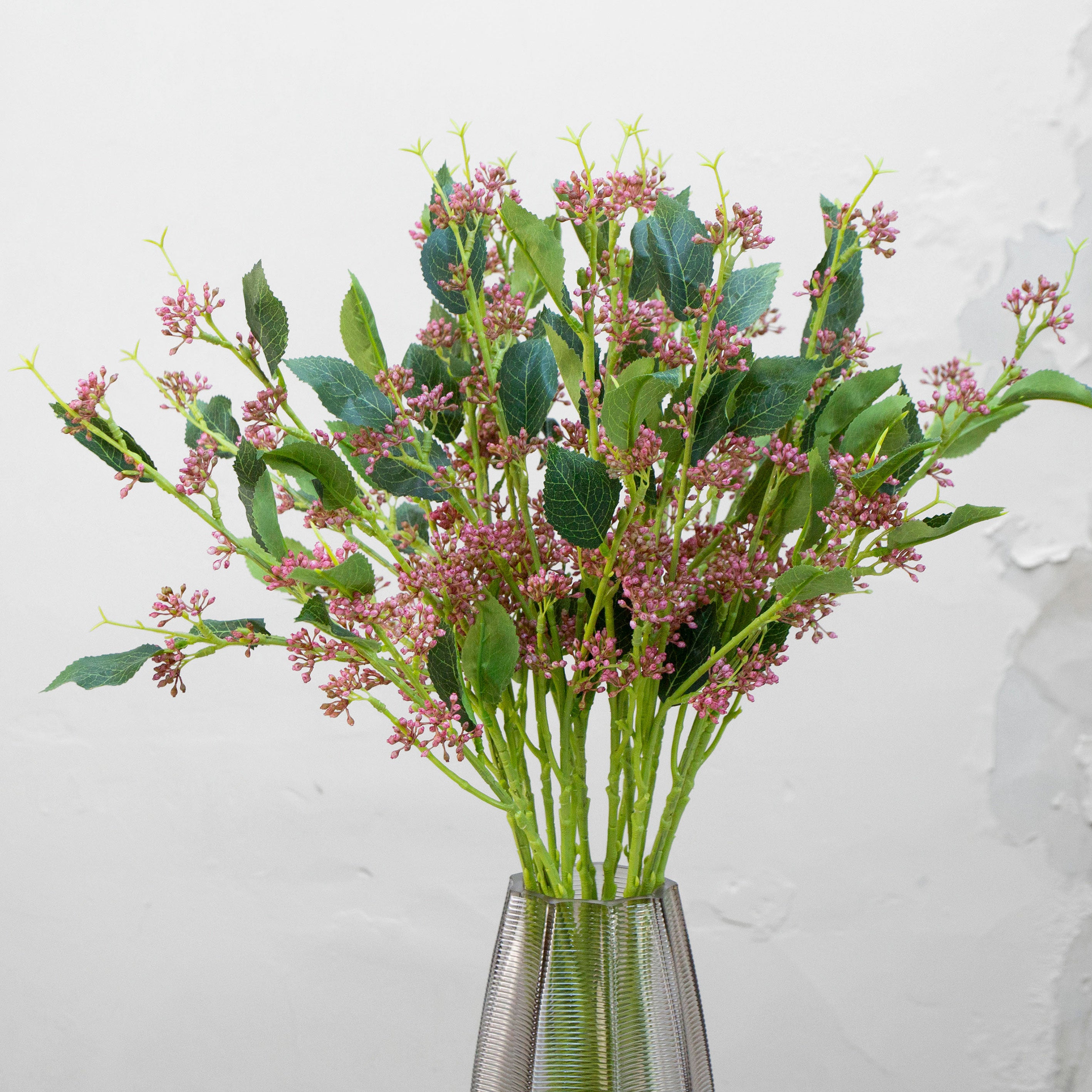 Close-up of artificial mauve-pink wild berry buds showing clustered detail and natural colour variation.