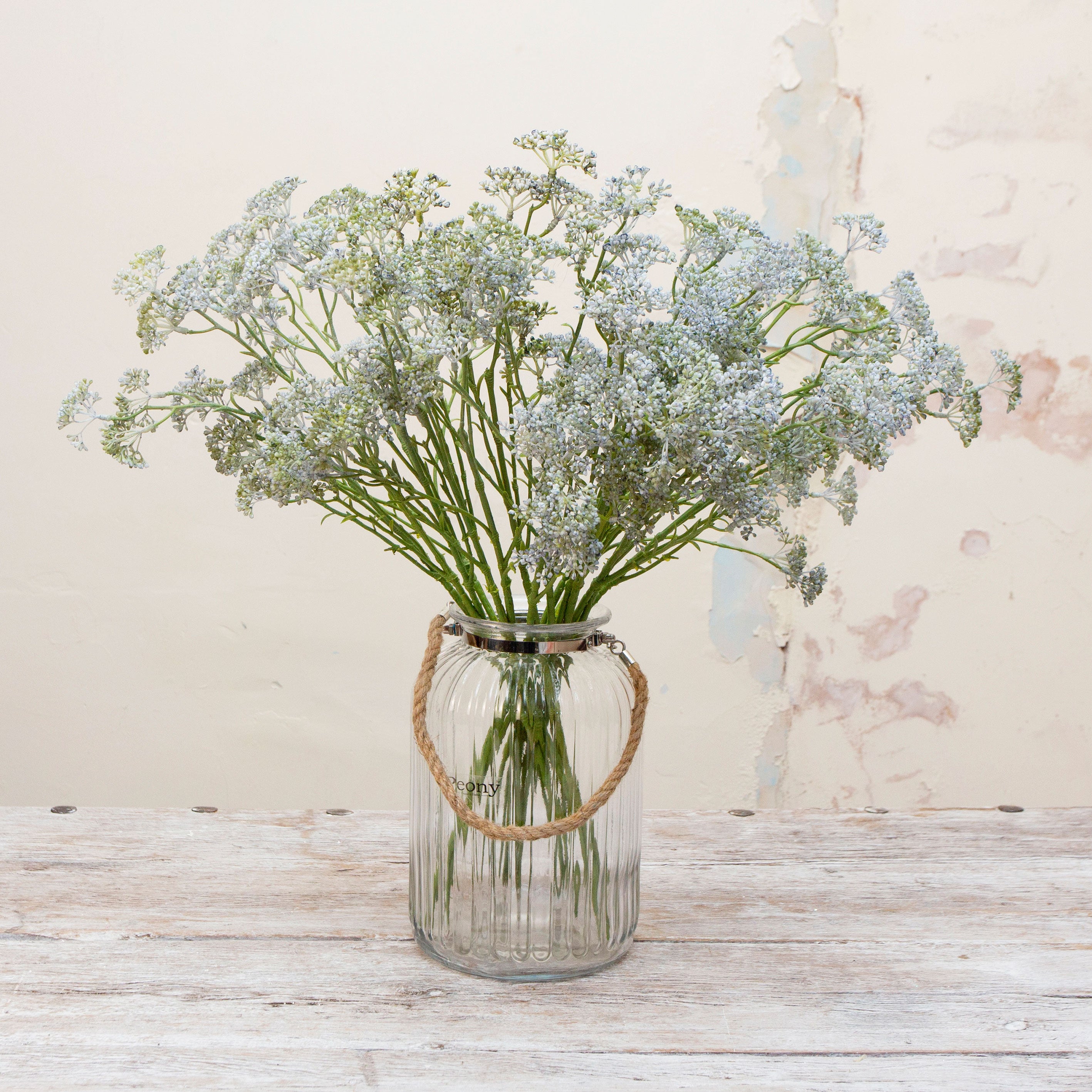 Artificial soft pale blue patrinia spray stems displayed together in a vase for styling purposes