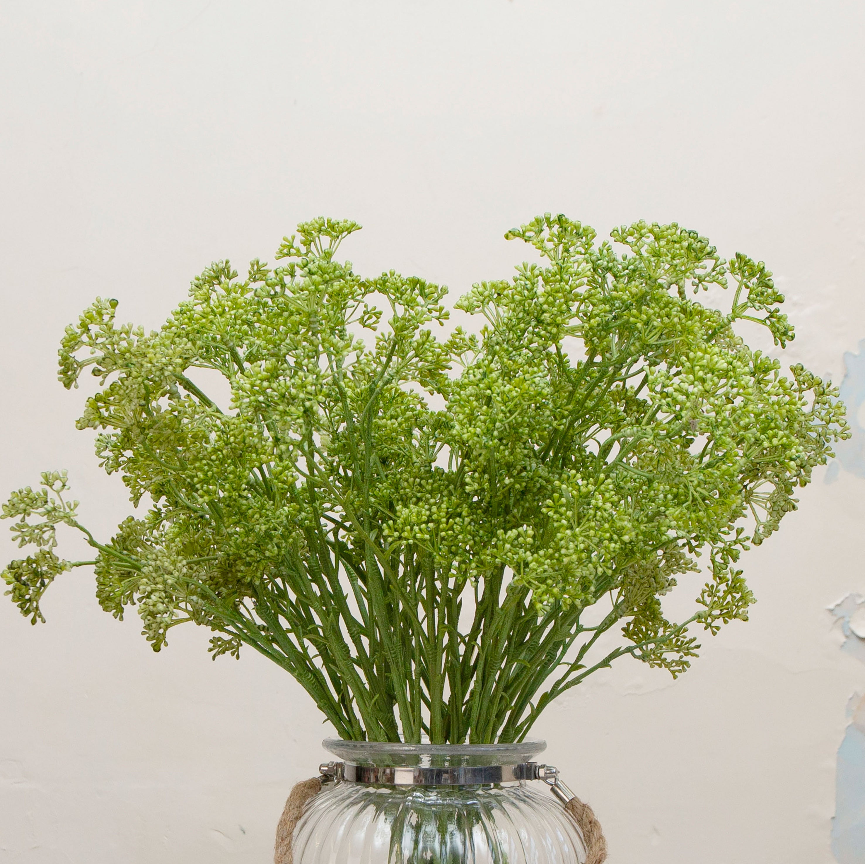 Close-up of artificial green patrinia flowers showing fine clustered detail