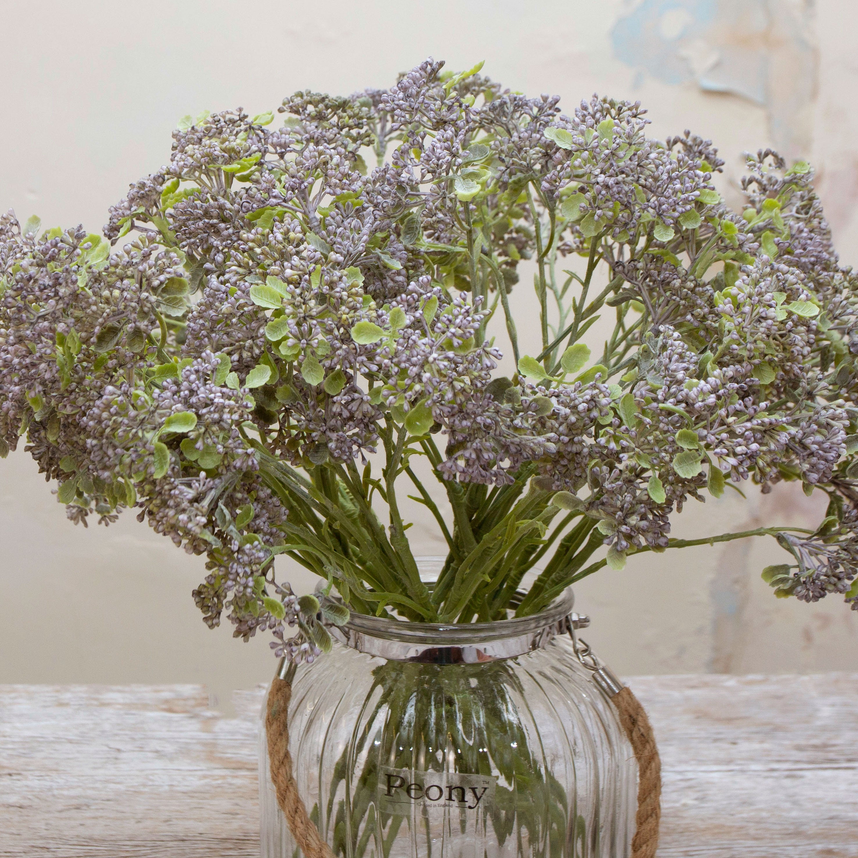 Close-up of artificial soft blue patrinia flowers showing fine clustered detail and subtle colour variation.