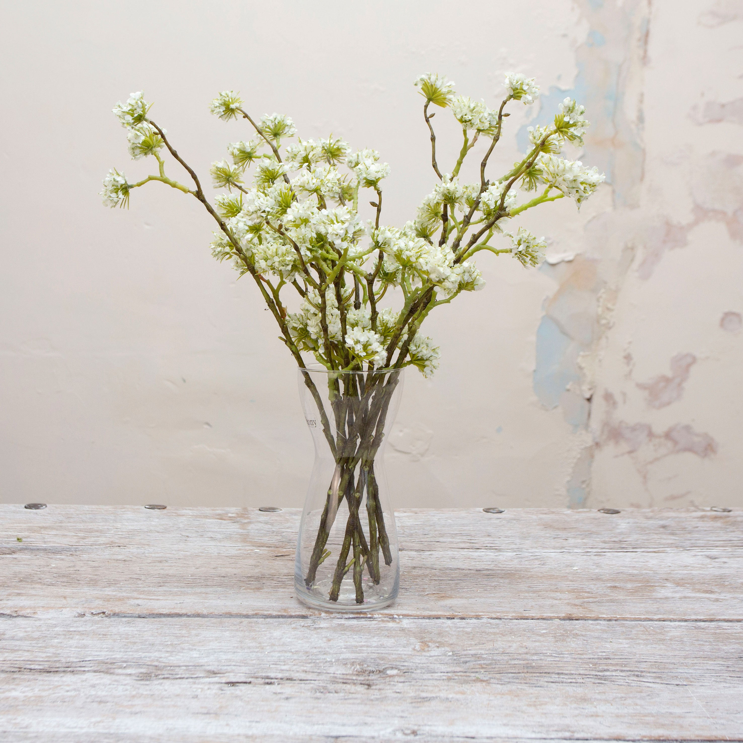 Artificial white buddleia spray stems displayed together in a vase for styling purposes.