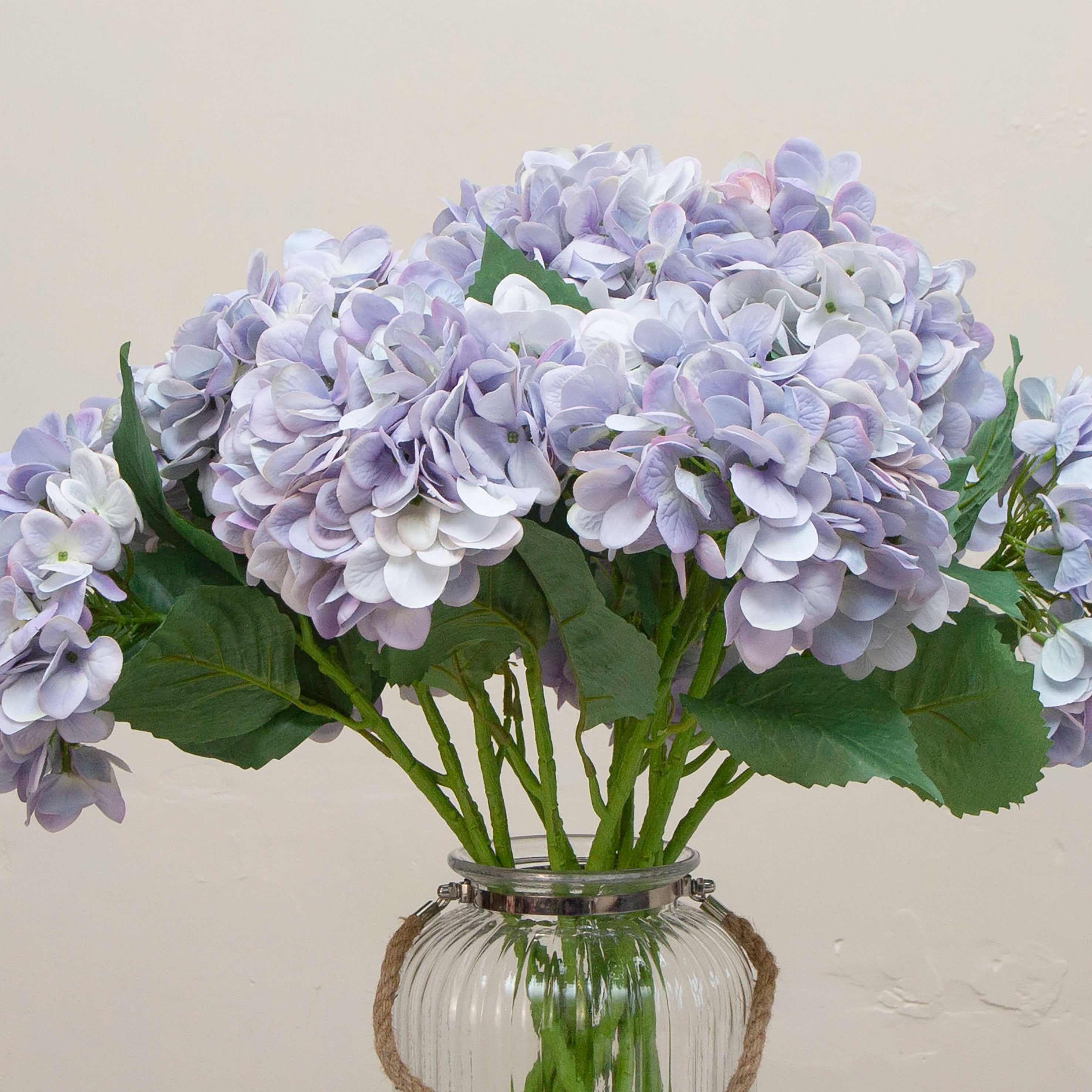 “Close-up of artificial pale blue hydrangea flowers, highlighting layered petals in soft blue hues with subtle lavender undertones and realistic texture.
