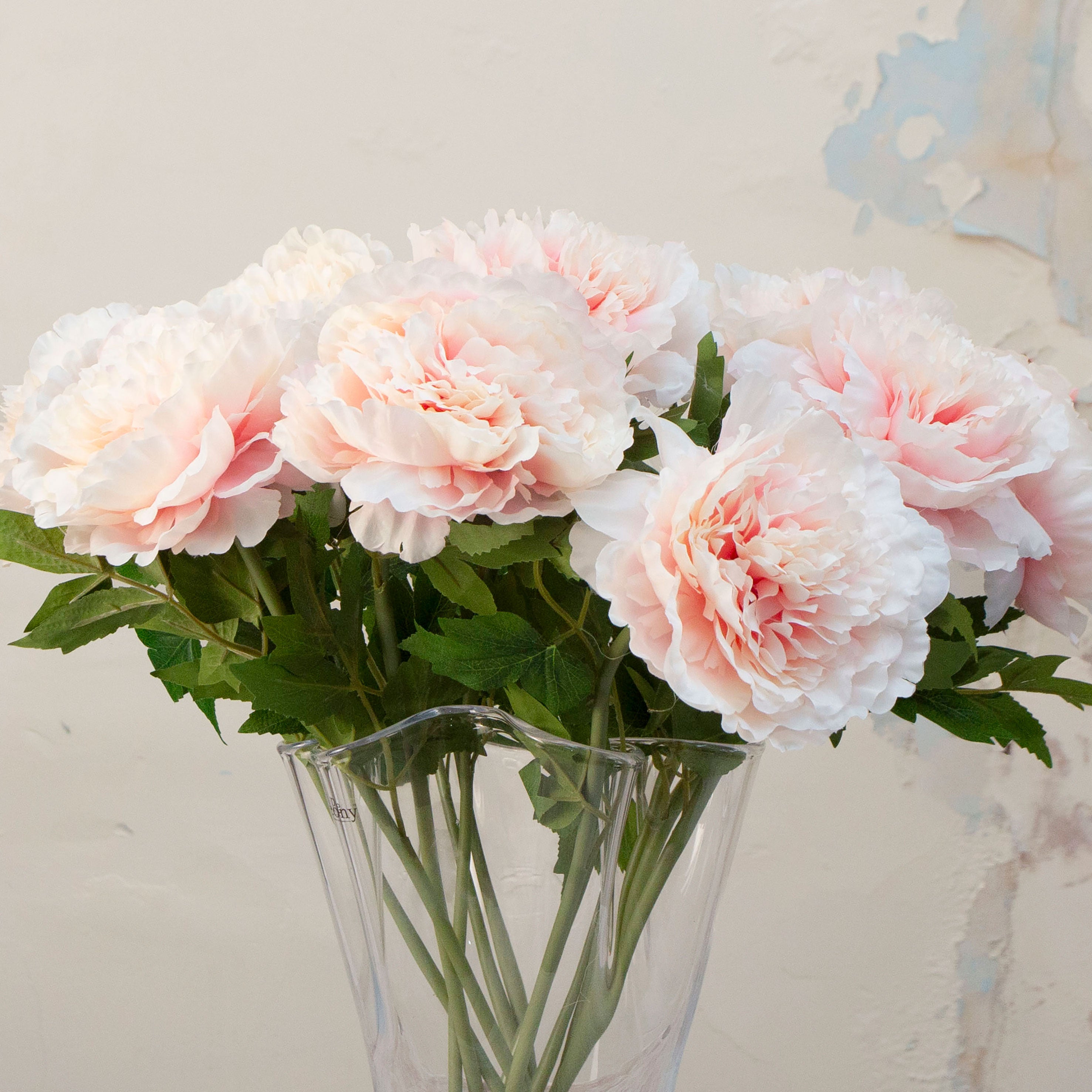 Close up of pink with peach toned artificial open head Peony Stem