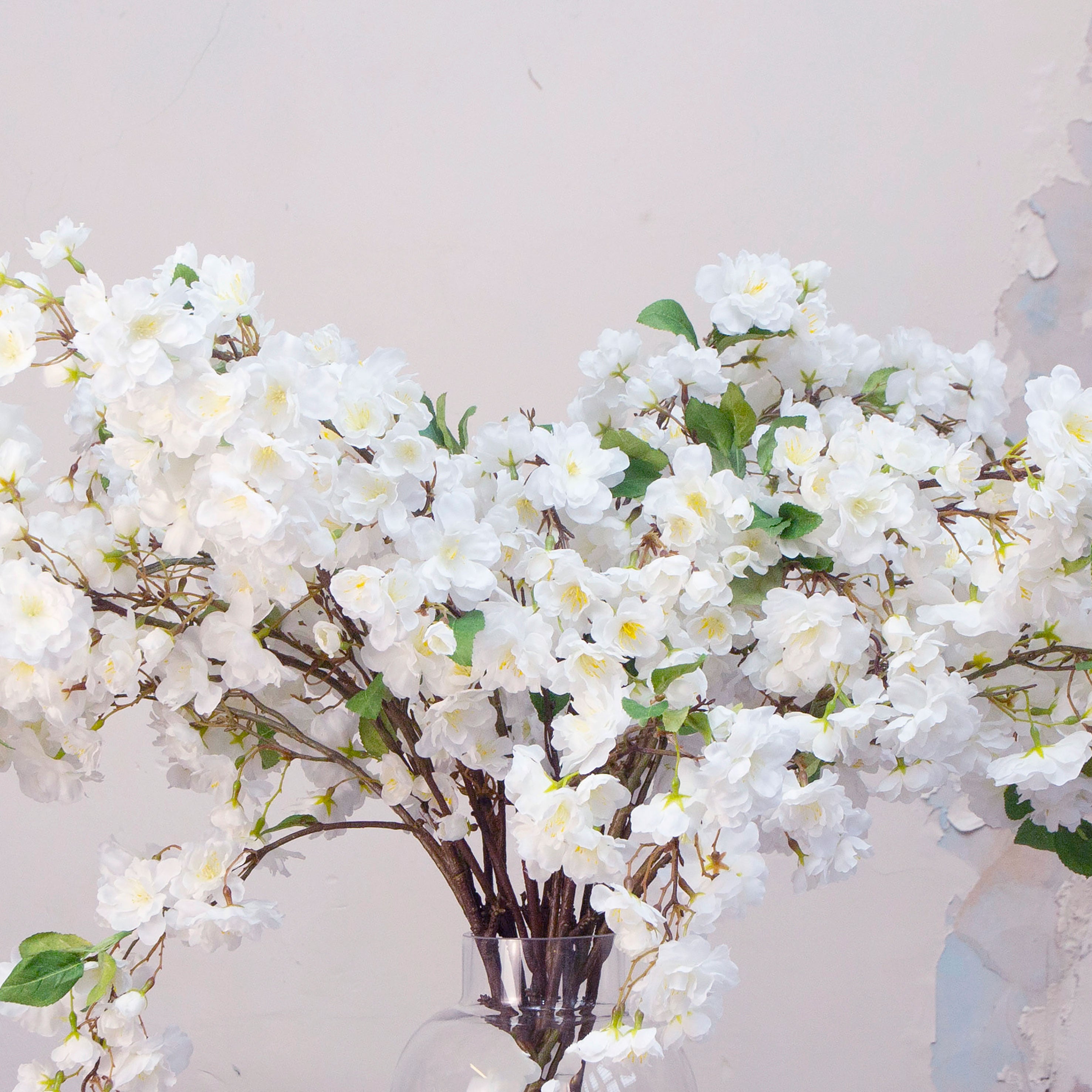 Close up artificial white cherry blossom stems