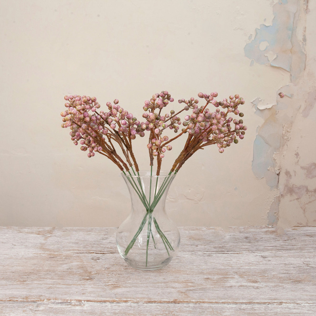 Artificial Berry Pick Stems with clusters of soft pink and mauve berries on natural brown branches displayed in a clear glass vase