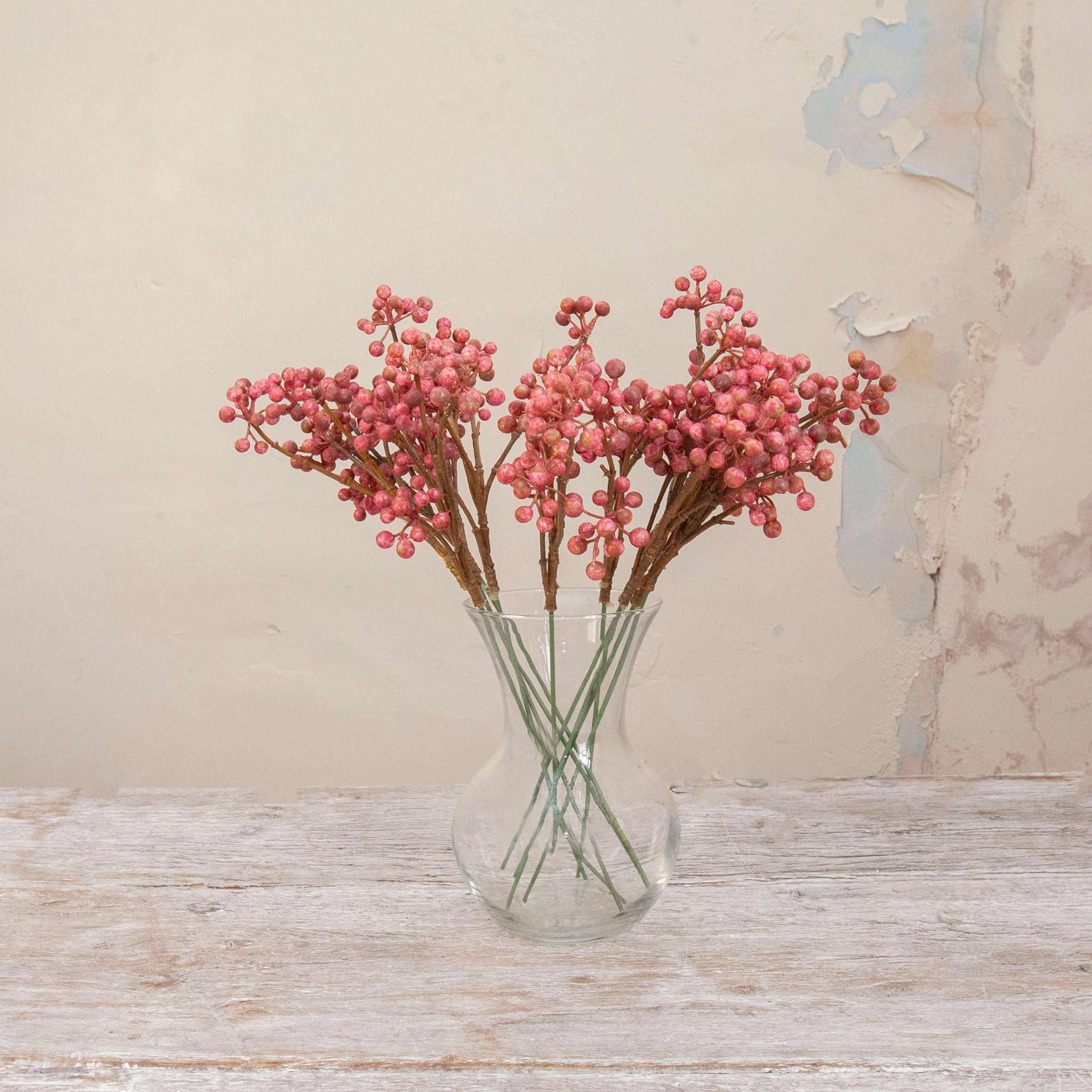 Artificial Berry Pick Stems with abundant clusters of vibrant pink berries on natural brown branches displayed in a clear glass vase