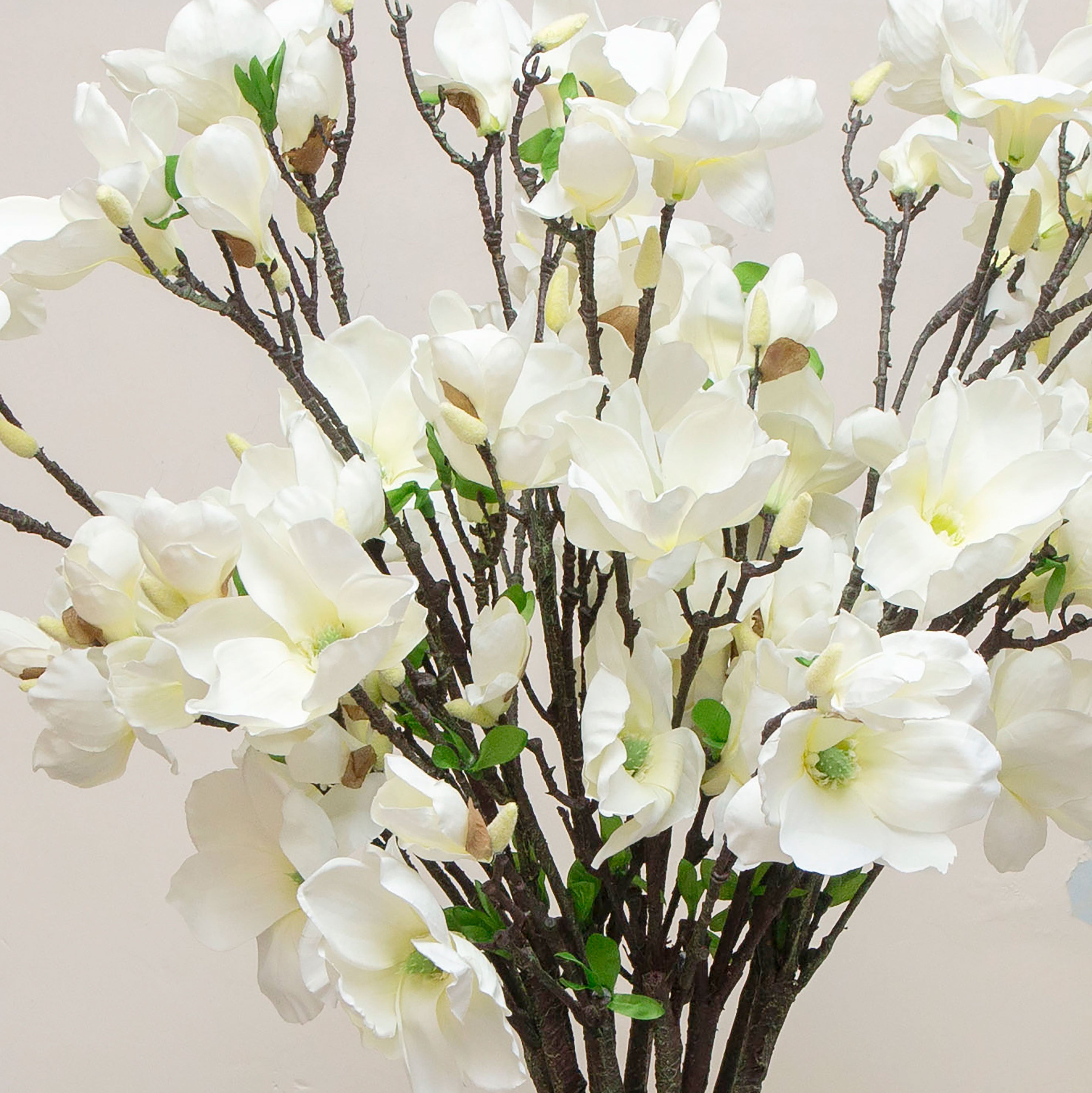 Close up of white artificial magnolia stems