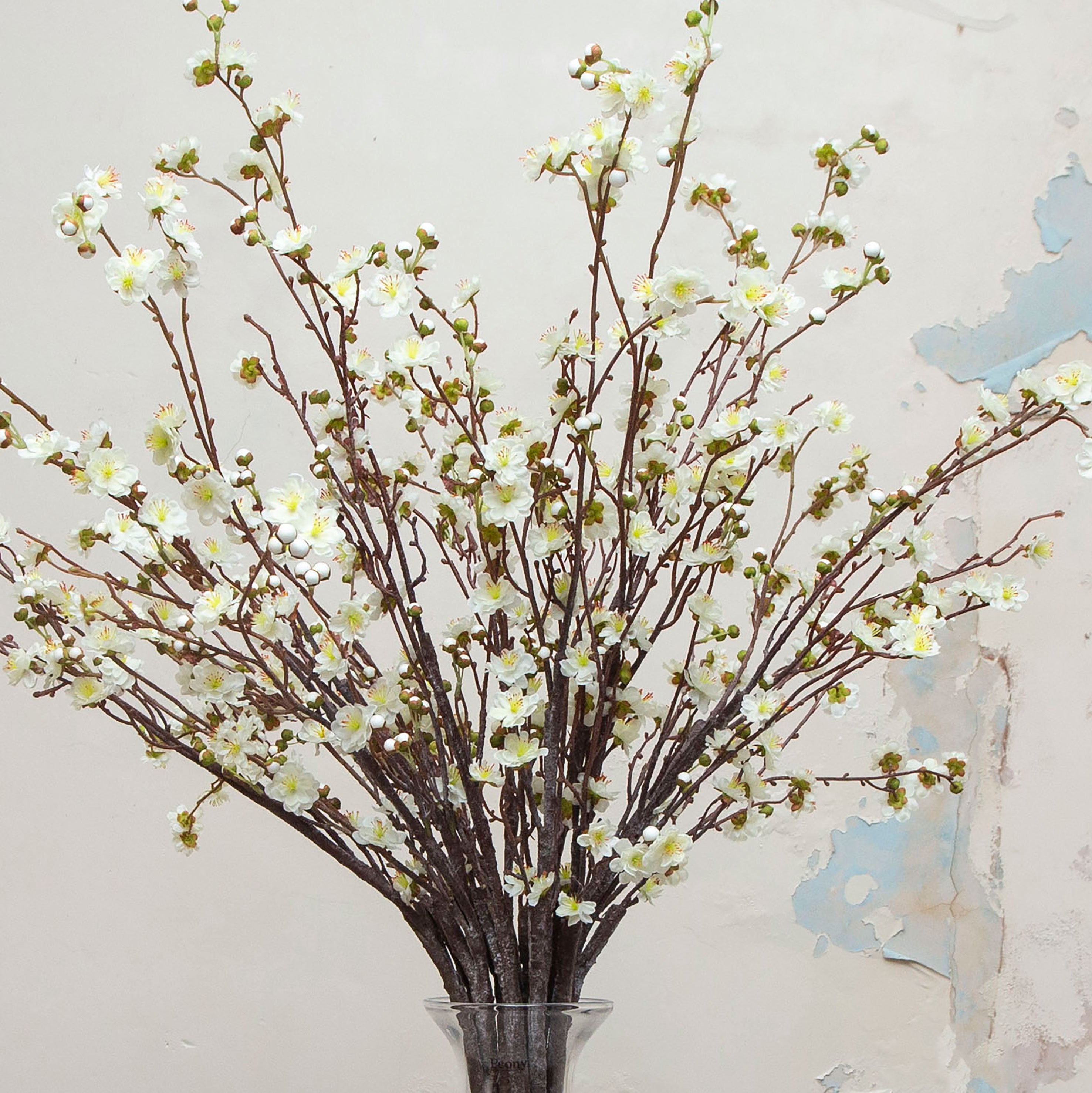 Close up of artificial cream blossom stems with yellow centres