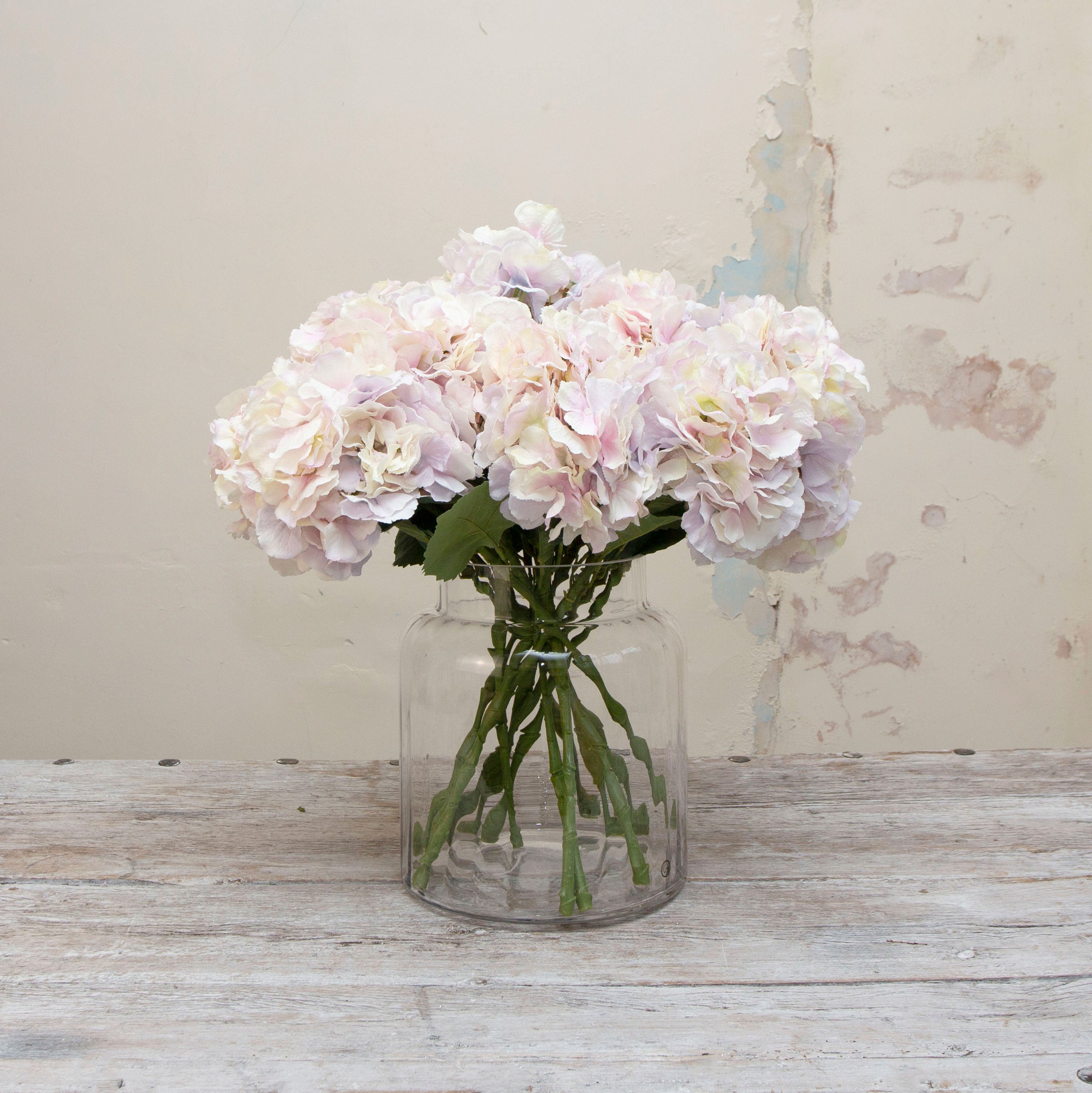 Artificial large headed hydrangeas stems with pale lilac and cream mixed petals displayed in vase