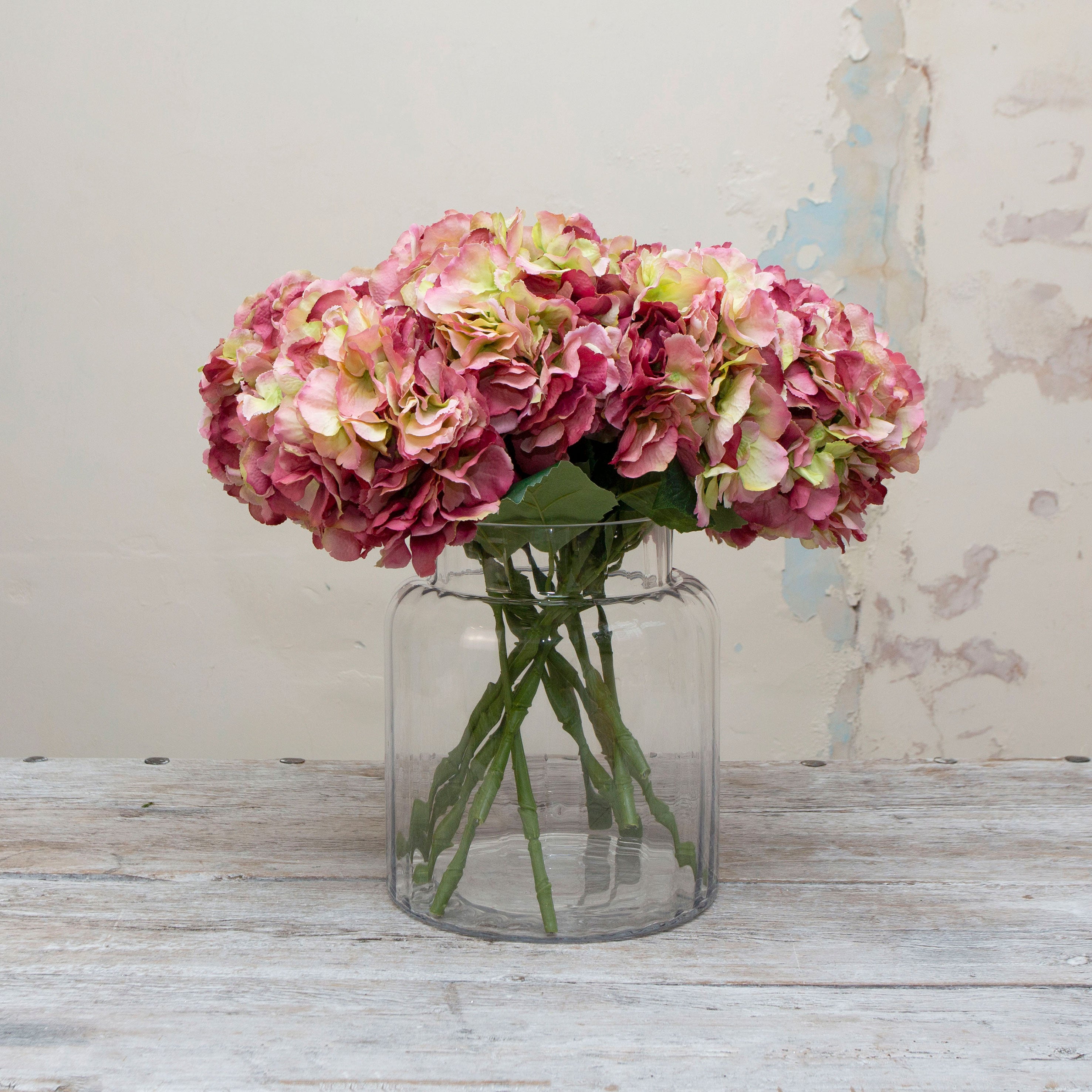 Large headed artificial hydrangea with pink and cream mixed petals displayed in vase