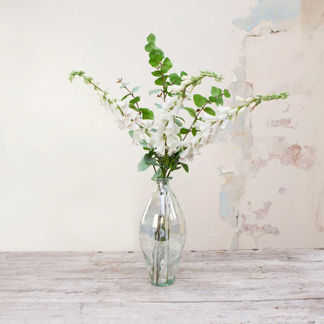 Artificial foxglove and eucalyptus in a lustre bottle vase