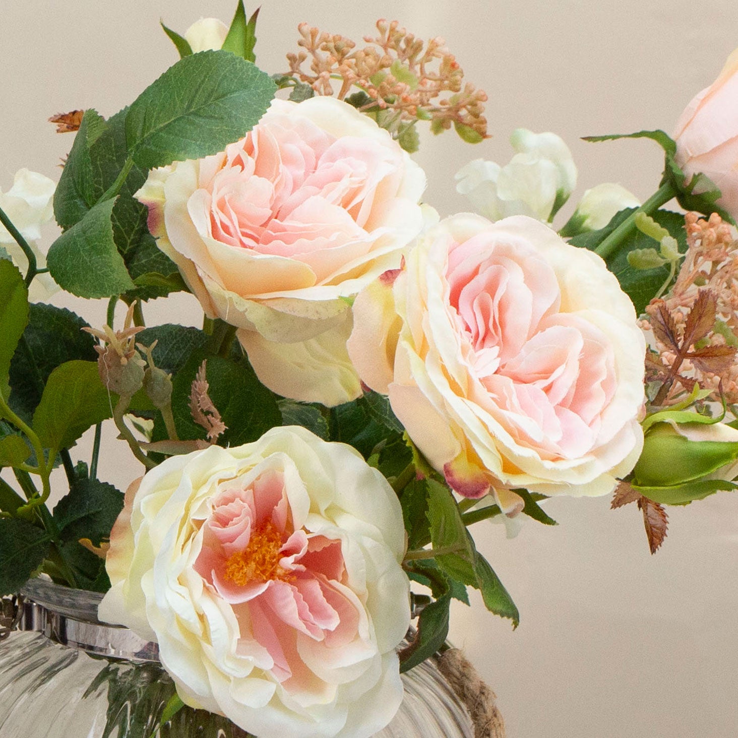 Artficial rose and sweet pea arrangement in a ribbed glass rope lantern vase