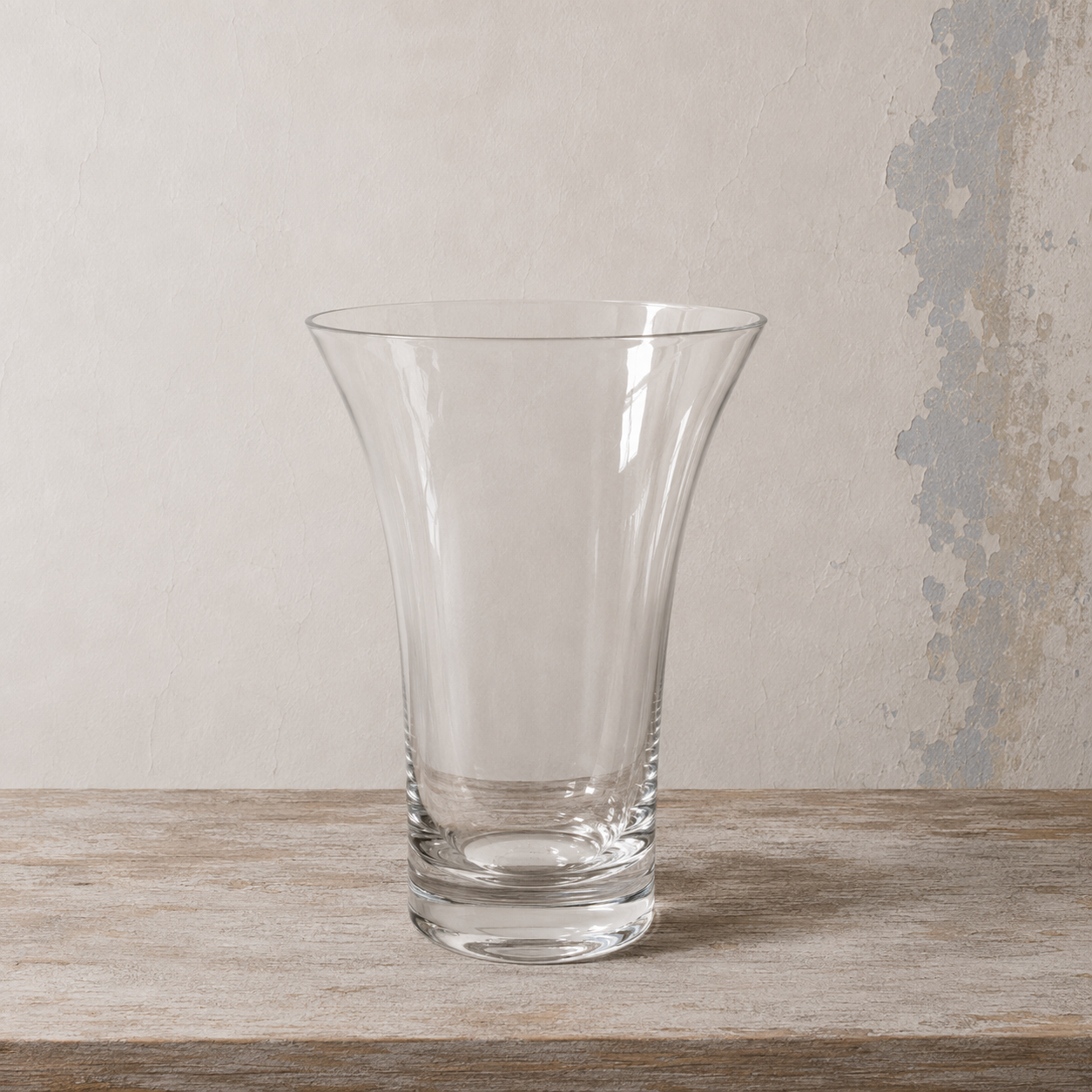 Clear glass chime vase with a gently flared shape and wide rim.