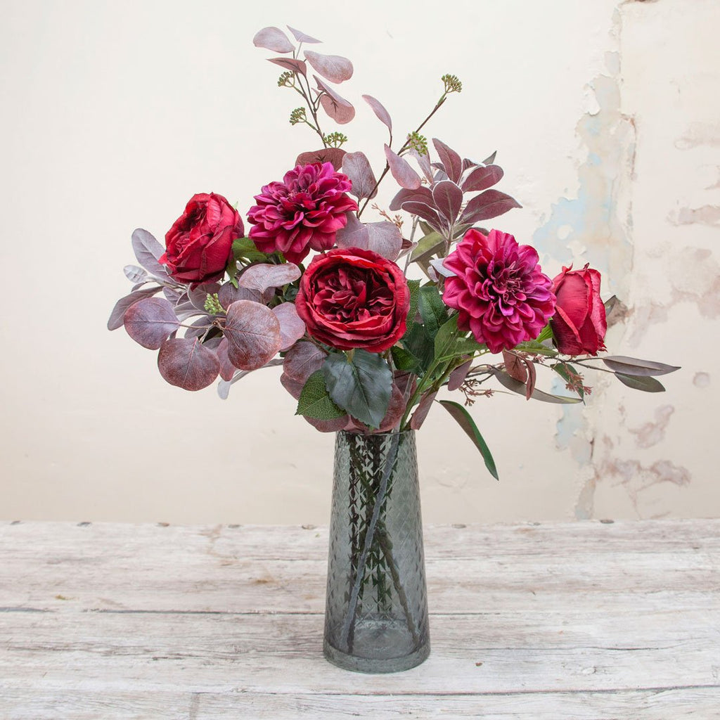 Purple Dahlias, Red Roses, Eucalyptus and Foliage in a Blue Tower Vase Peony