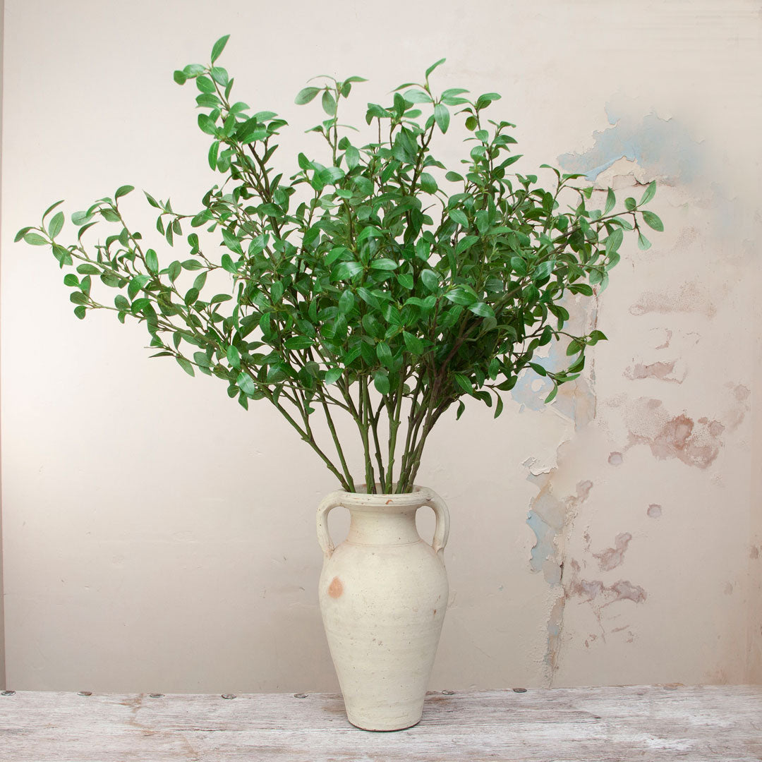 Artificial privet stems displayed in ceramic vase for styling purposes only