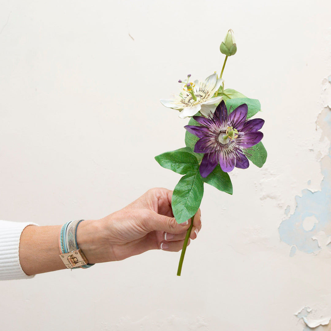 Single artificial passion flower stem with purple and cream bloom and green foliage