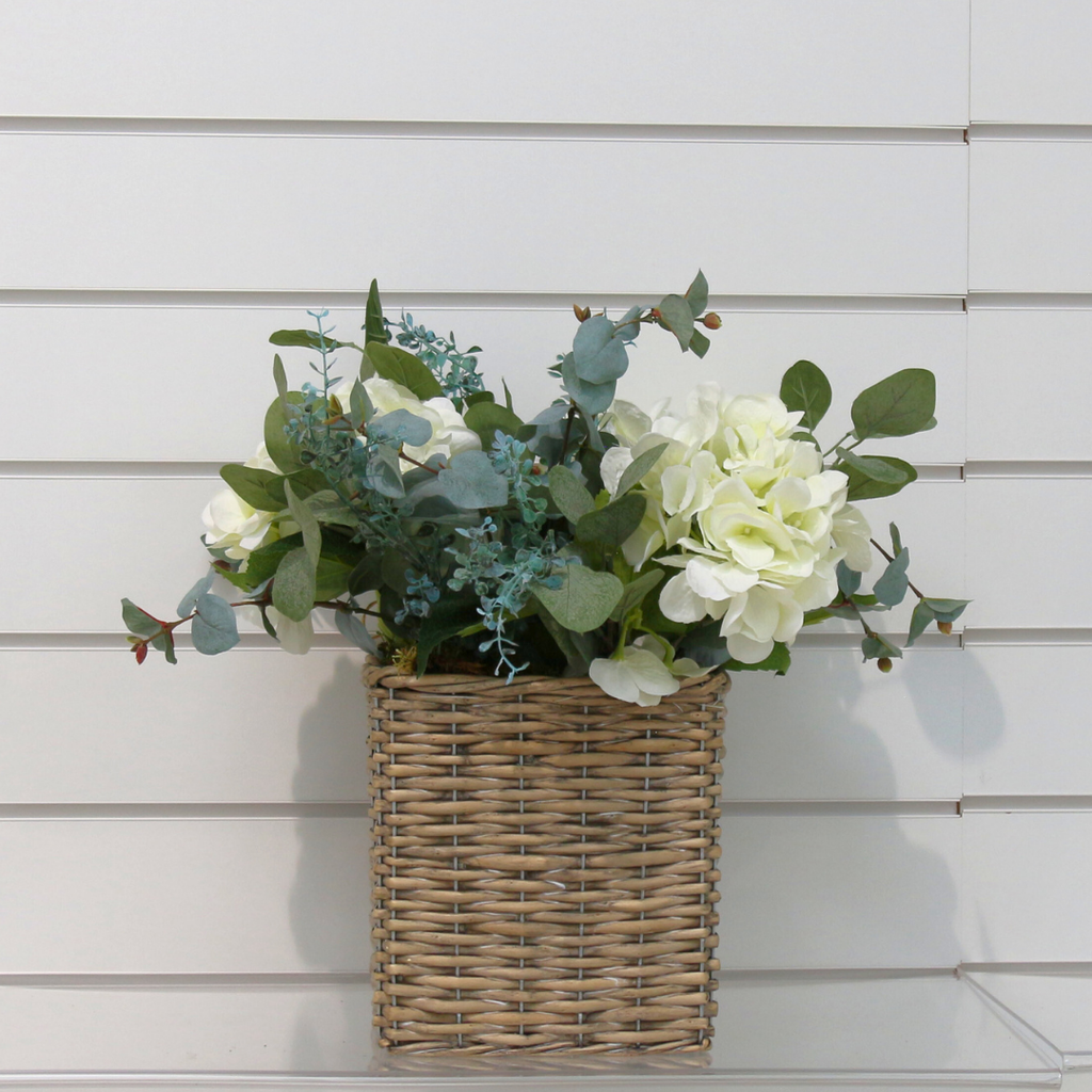 A Woven Basket of Eucalyptus and Hydrangeas