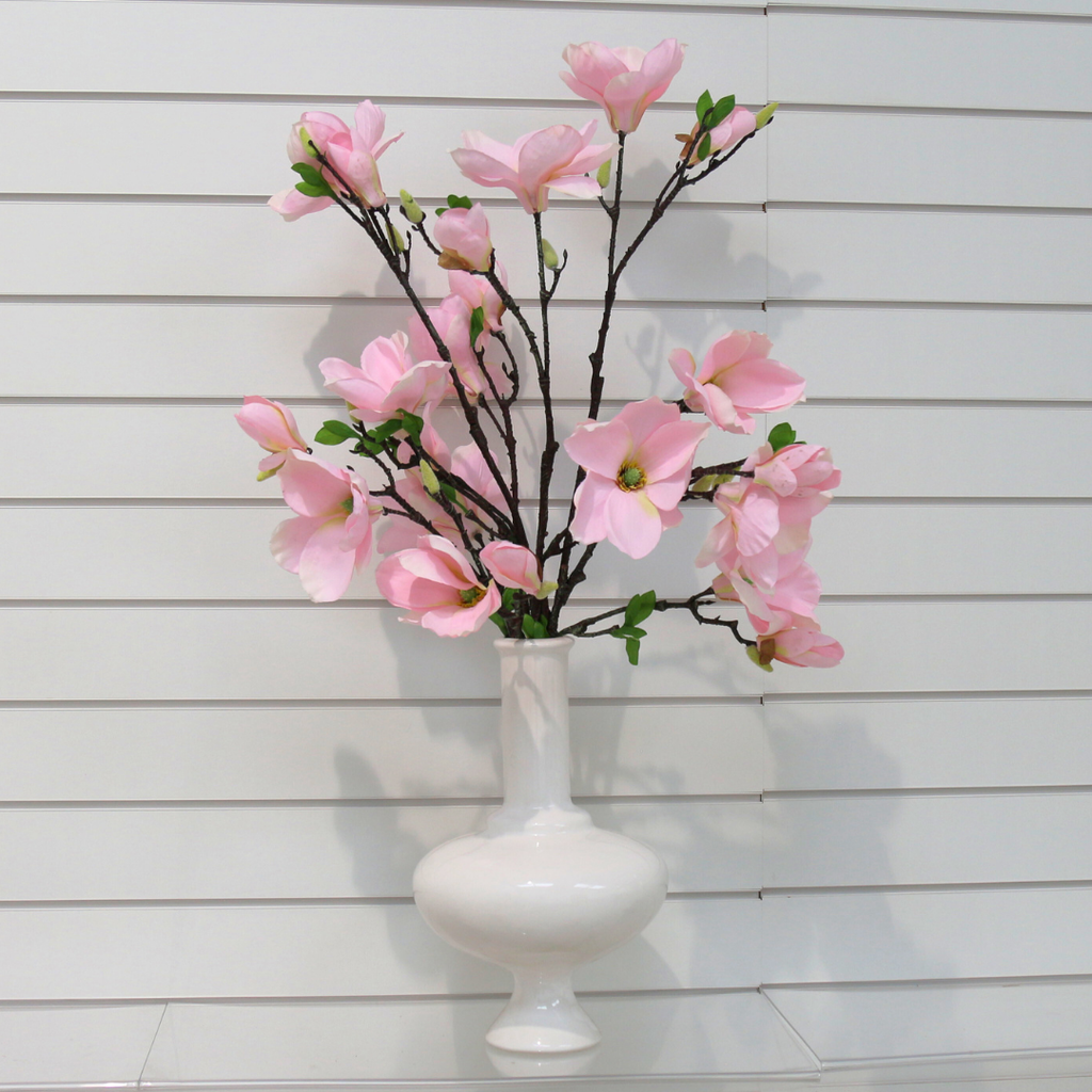 Branches of Pink Magnolia fill a Unique Ceramic Tall White Vessel