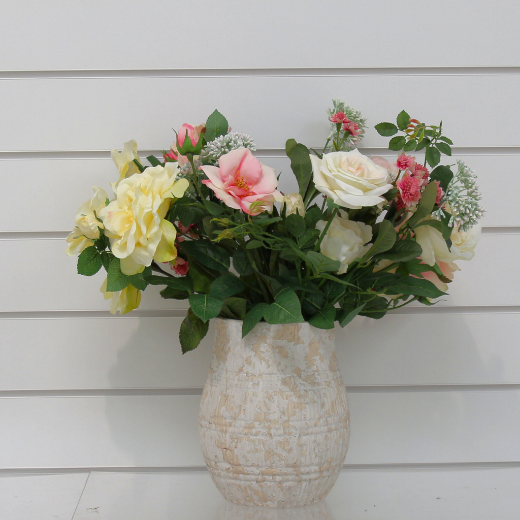 A Colourful Mix of Roses and Foliage in a Rustic Urn 