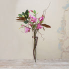 Artificial magnolia arrangement with contorted willow in a tall Conical Vase