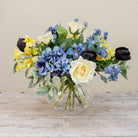 Artificial blue and yellow floral bowl arrangement with Roses, Hydrangeas and Tulips