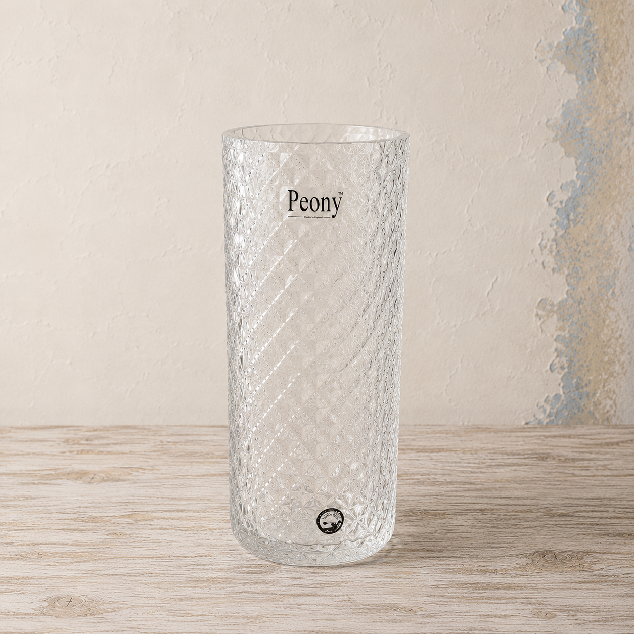 Clear cut glass effect cylinder vase with an intricate diamond textured pattern.
