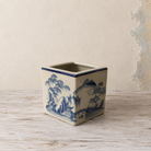 Blue and white Oriental ceramic cube planter with a traditional landscape design.
