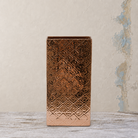 Tall rectangular copper pot with an embossed geometric textured design.