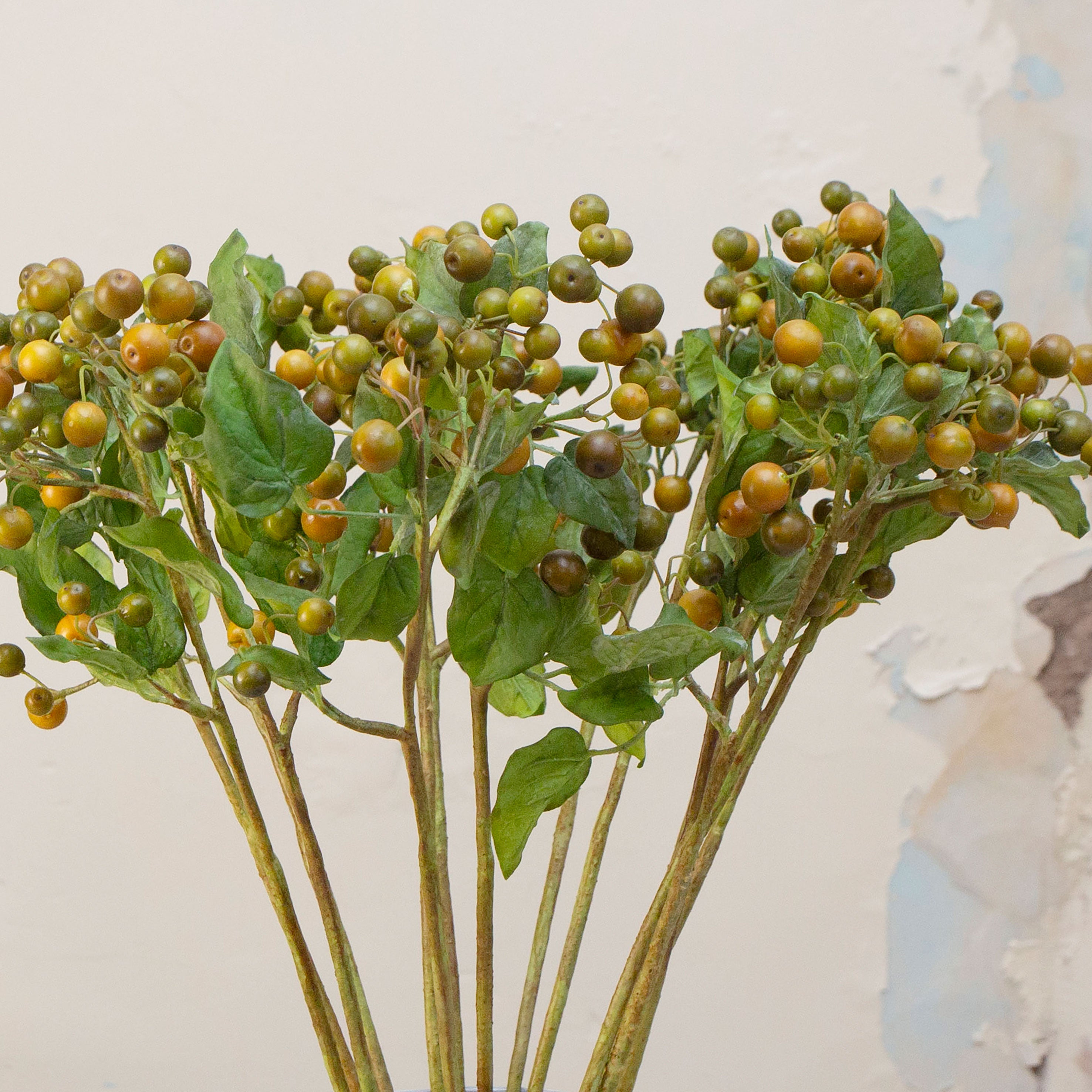Close-up of artificial Yoshino berries, showing rounded green berries with gentle tonal variation, fine stem texture and realistic leaf detailing
