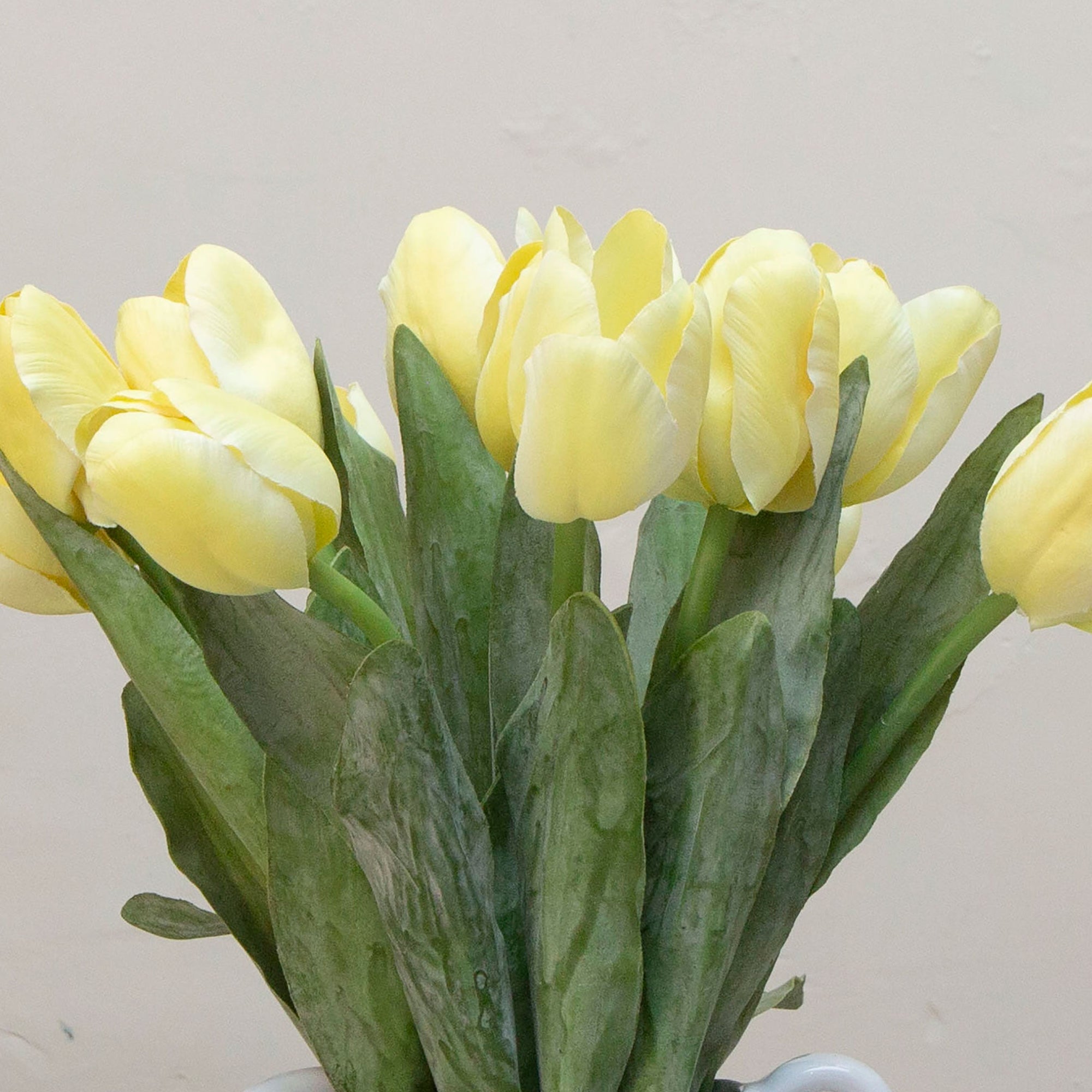 Close-up of artificial yellow tulip flowers showing smooth petals and natural colour