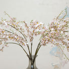 Close-up of artificial pale pink dancing orchid flowers showing delicate petals and soft colour detail.