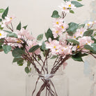 Close-up of artificial pale pink clematis flowers, highlighting star-shaped petals, gentle colour variation, soft yellow centres and fine stem detailing
