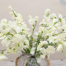 Close-up of artificial bridal white sweet pea flowers showing soft petals and gentle white colour detail
