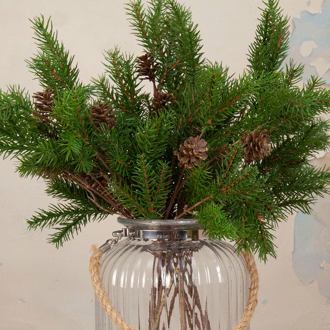Close up artificial Pine Cone Stem with realistic green pine foliage and brown pine cones