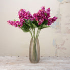 Artificial purple-pink conehead hydrangea stems displayed together in a vase for styling purpose
