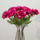 Close-up of artificial deep pink peony flowers showing layered petals and rich colour detai