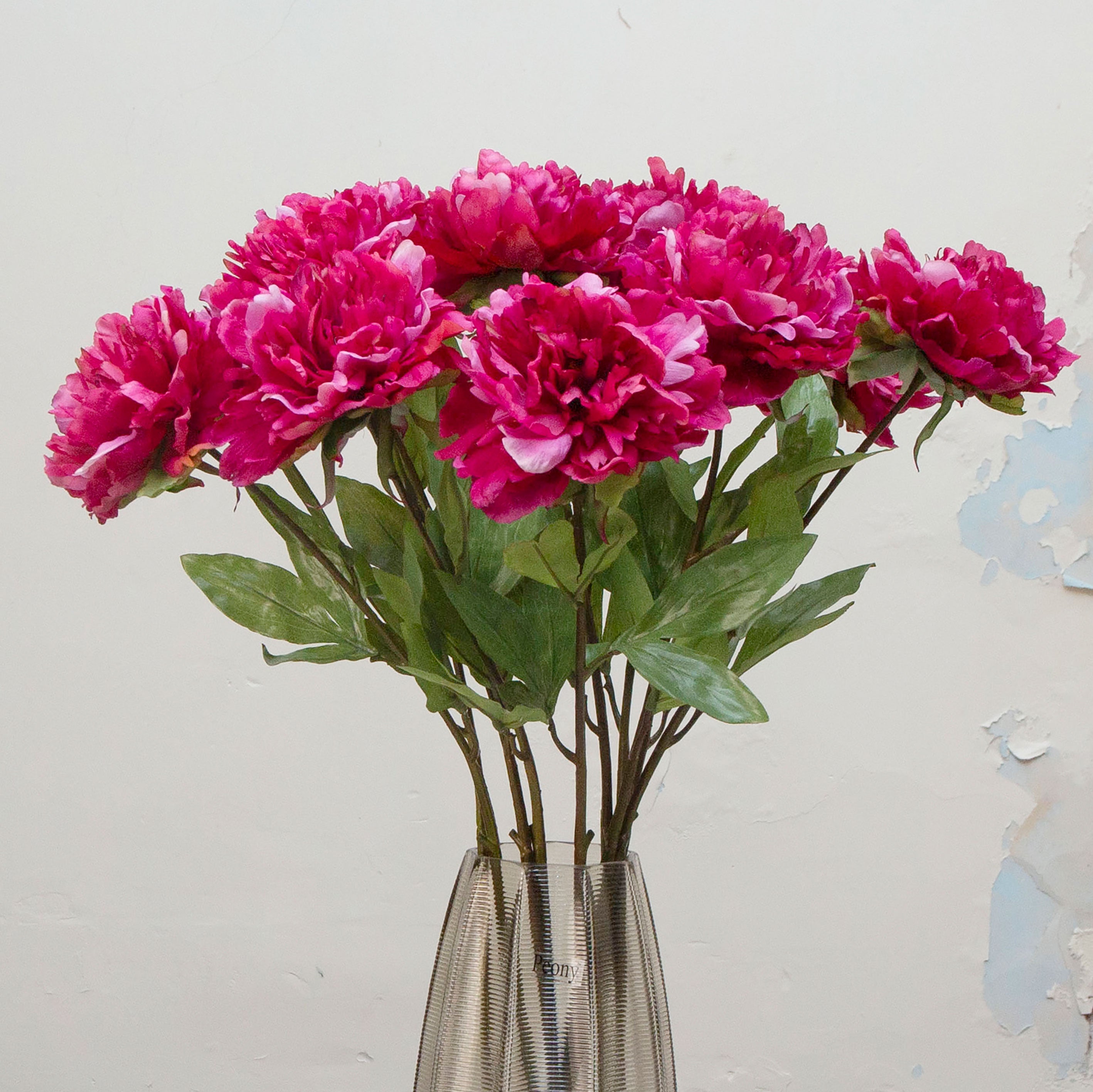 Close-up of artificial deep pink peony flowers showing layered petals and rich colour detai