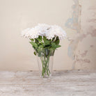 Artificial White Dahlia Stems with full white blooms and realistic green foliage displayed in a clear glass vase