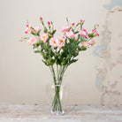 Artificial pale pink lisianthus spray stems displayed together in a vase for styling purposes.