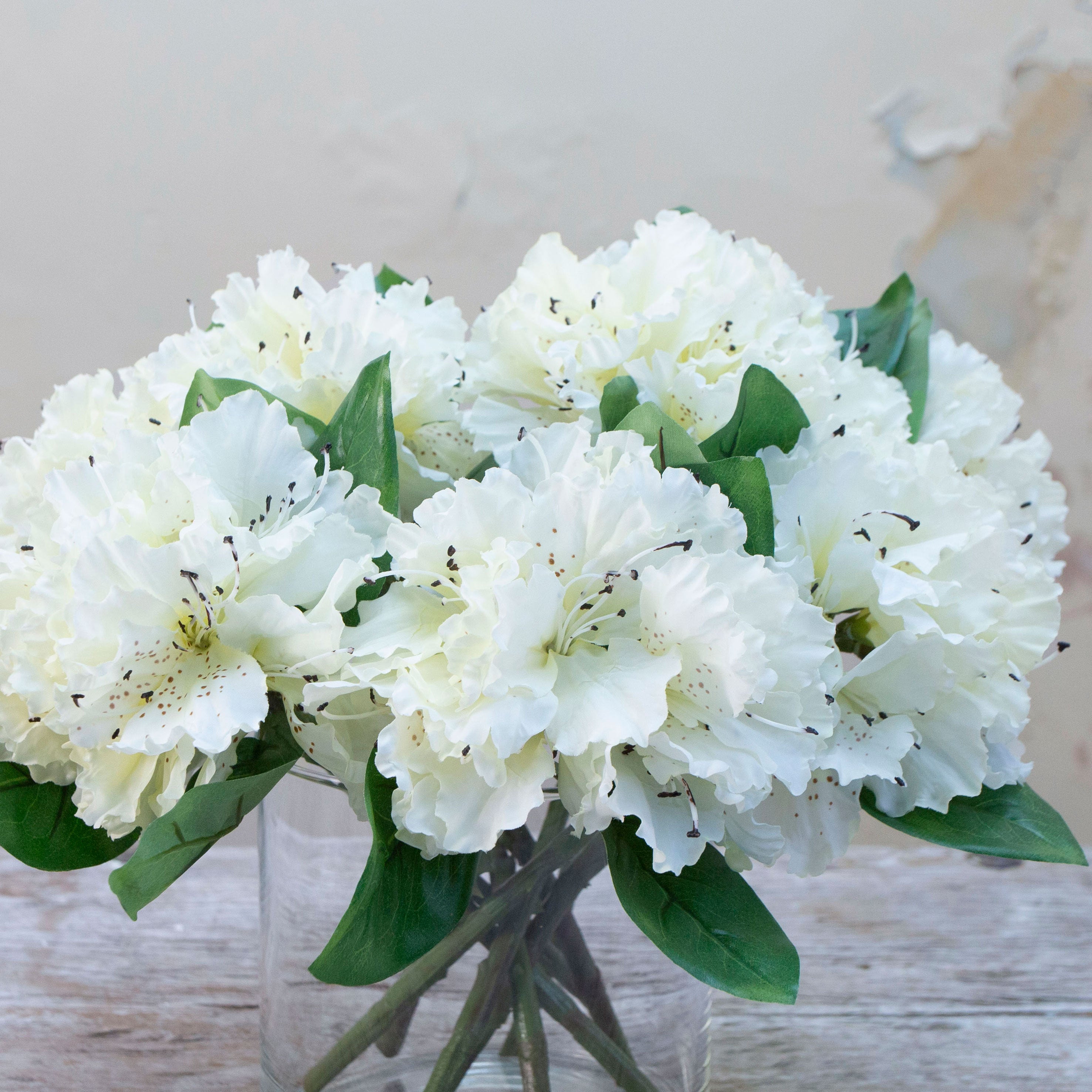 Close-up of artificial bridal white rhododendron flowers showing layered petals and delicate colour detail.