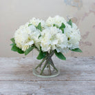 Artificial bridal white rhododendron stems picks displayed together in a vase for styling purposes