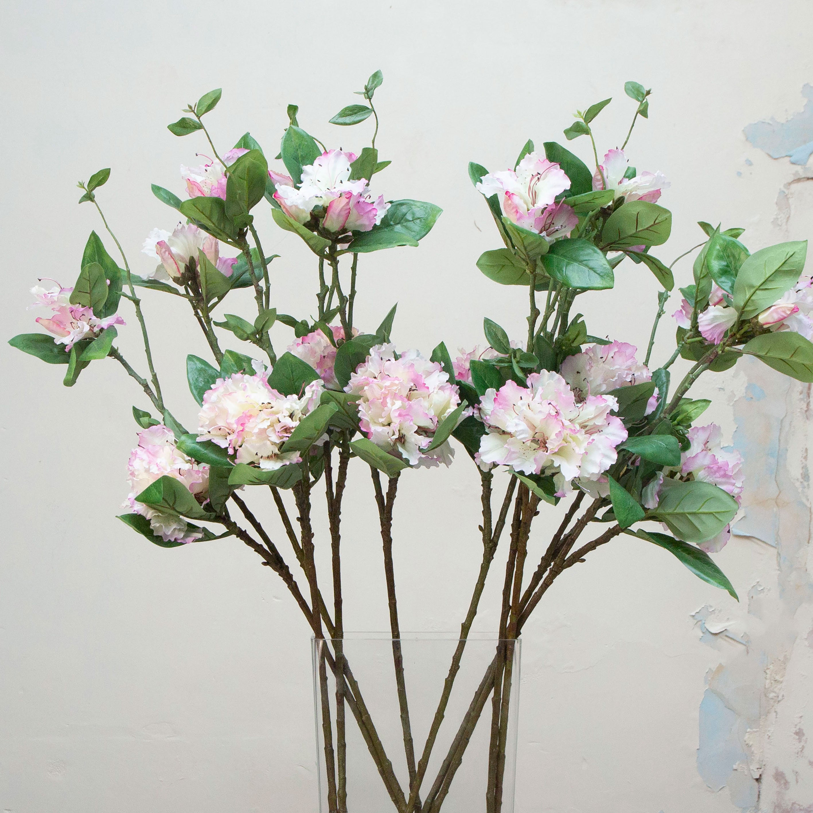 Close-up of artificial pink and white rhododendron flowers showing layered petals and gentle colour variation.