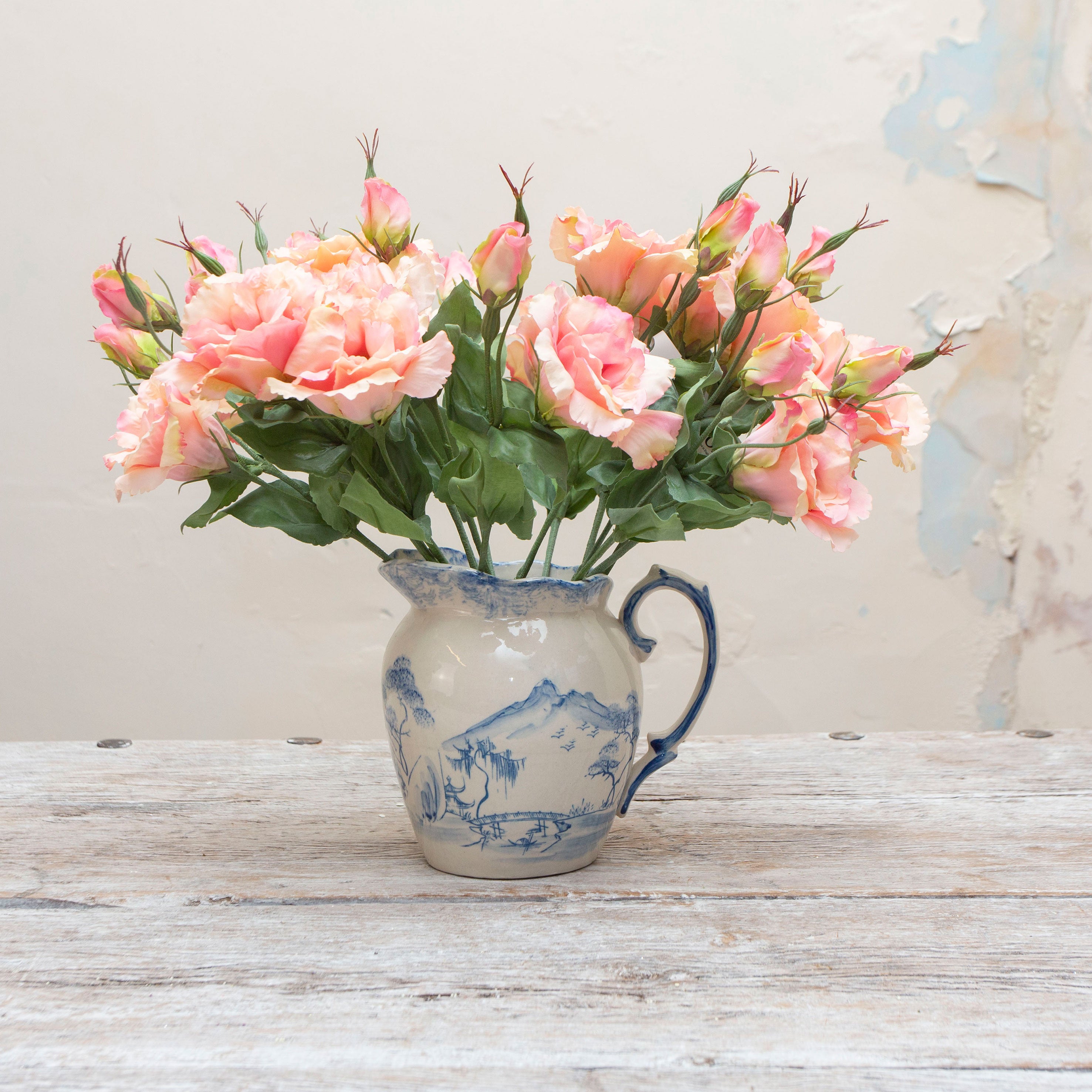 Artificial soft peach blush lisianthus picks displayed together in a vase for styling purposes.
