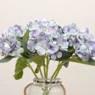 Close-up of artificial soft blue lilac hydrangea flowers showing clustered blooms and gentle colour variation