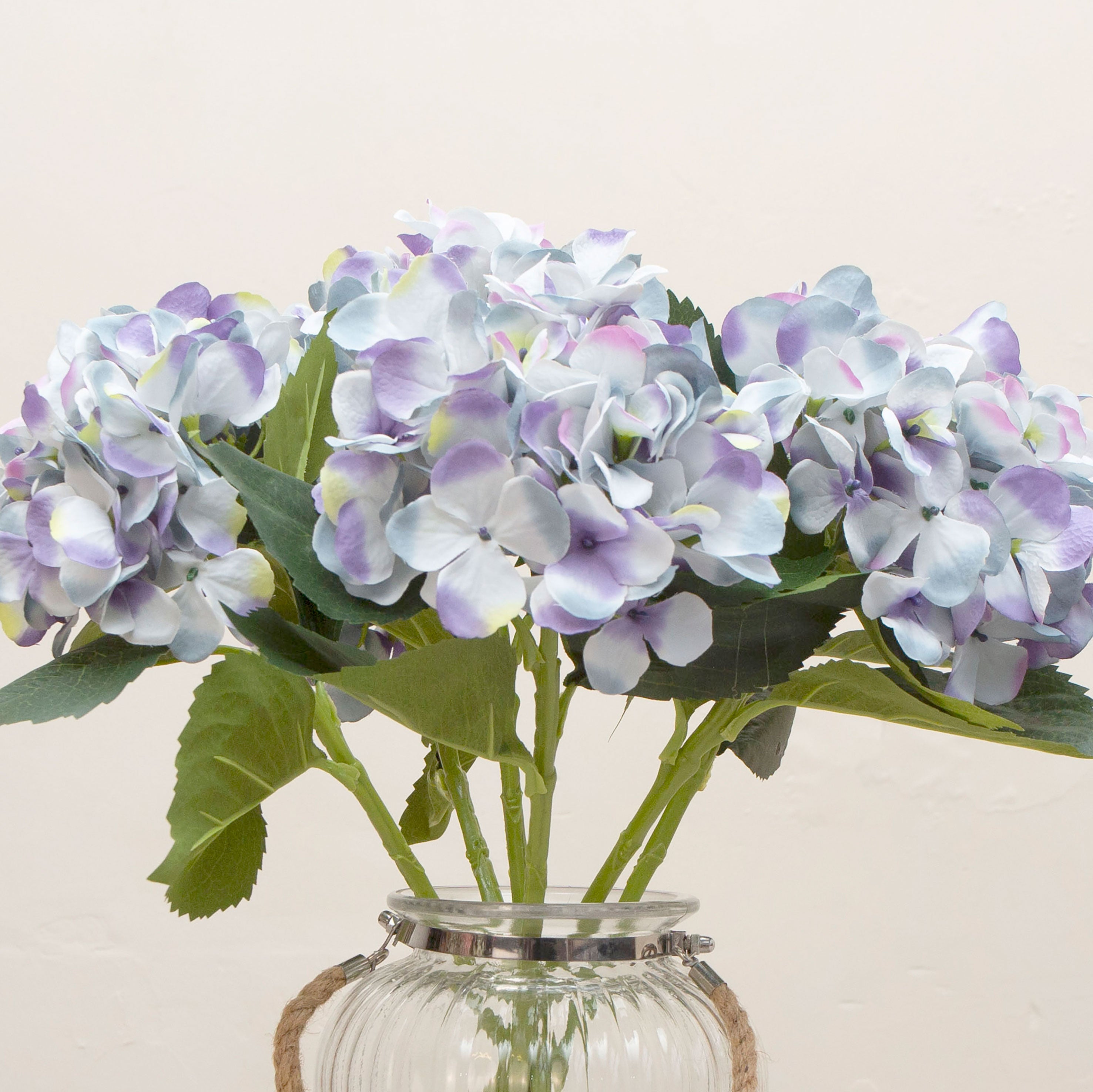 Close-up of artificial soft blue lilac hydrangea flowers showing clustered blooms and gentle colour variation