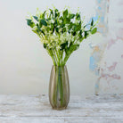 Artificial bridal white wild berry stems displayed together in a vase for styling purposes